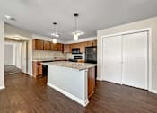 Thumbnail 11 of 42 - A Kitchen With a White Island at Capitol Grove Apartments, Des Moines, IA, 50317