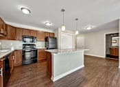 Thumbnail 8 of 42 - A Kitchen With a Black Oven at Capitol Grove Apartments, Iowa, 50317