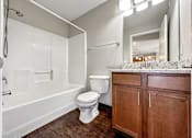 Thumbnail 14 of 42 - A Bathroom With Wooden Cabinets at Capitol Grove Apartments, Des Moines, 50317