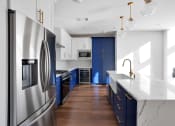 Thumbnail 13 of 86 - Kitchen with stainless steel appliances and blue cabinets at 44 Washington, Kansas City, MO