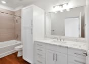 Thumbnail 27 of 86 - Bathroom with white cabinets at 44 Washington, Missouri