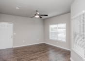 Thumbnail 36 of 37 - an empty living room with a ceiling fan and a window