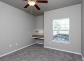 Thumbnail 33 of 37 - an empty room with a ceiling fan and a window