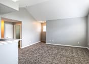 Thumbnail 21 of 44 - A spacious room with carpeted floor and white walls.