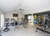 Thumbnail 18 of 34 - A spacious home gym with a variety of exercise equipment.