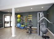 Thumbnail 17 of 34 - A gym with a wall that says "Strong Brave Honest" and a variety of equipment.