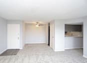 Thumbnail 27 of 34 - A room with a carpeted floor and a ceiling fan.