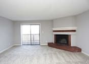 Thumbnail 26 of 34 - A living room with a fireplace and sliding glass doors.