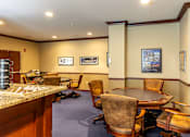 Thumbnail 13 of 14 - A conference room with a table surrounded by chairs.
