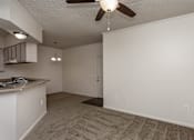 Thumbnail 19 of 23 - A room with a ceiling fan and a carpeted floor.