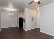 Thumbnail 16 of 23 - A room with a ceiling fan and a black refrigerator.
