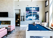 Thumbnail 26 of 53 - an open living room with a pool table and a fireplace  at Waterside Residences on Quivira, Lenexa, 66215