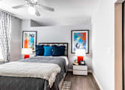 Thumbnail 1 of 53 - a bedroom with a bed and a ceiling fan  at Waterside Residences on Quivira, Lenexa, Kansas