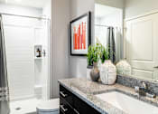 Thumbnail 6 of 53 - a bathroom with a sink and a shower and a mirror  at Waterside Residences on Quivira, Kansas