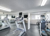 Thumbnail 7 of 18 - A gym with treadmills and exercise bikes.
