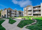 Thumbnail 15 of 18 - A sunny day at a residential complex with a clear blue sky.
