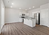 Thumbnail 29 of 36 - an empty kitchen with white cabinets and a stainless steel refrigerator at Hillcrest Village, Springdale, AR 72762