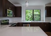 Thumbnail 67 of 86 - Wooden cabinets in kitchen with appliances at 44 Washington, Kansas City, MO