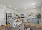 Thumbnail 21 of 36 - a kitchen and dining room with a table and chairs at Hillcrest Village, Arkansas, 72762