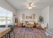Thumbnail 25 of 36 - a living room with couches and a table and a ceiling fan at Hillcrest Village, Springdale Arkansas