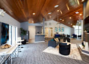 Thumbnail 15 of 34 - A modern living room with a wooden ceiling and grey carpet.