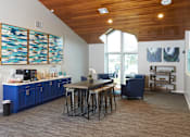 Thumbnail 16 of 34 - A kitchen with blue cabinets and a wooden ceiling.