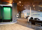 Thumbnail 12 of 34 - A modern office space with wood floors and a green accent wall.