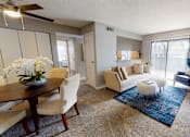 Thumbnail 6 of 34 - A living room with a dining table and chairs.