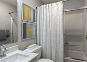 Thumbnail 22 of 36 - A white bathroom with a sink, toilet, and shower.