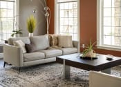 Thumbnail 7 of 50 - a living room with a couch and a coffee table
