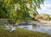 Thumbnail 2 of 50 - a bench sits next to a pond in a park