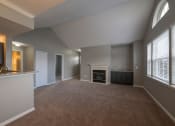 Thumbnail 36 of 50 - a living room with a fireplace and a kitchen