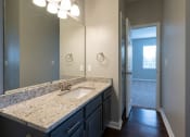 Thumbnail 43 of 50 - a bathroom with a sink and a mirror