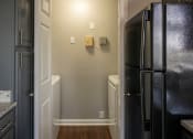 Thumbnail 40 of 50 - a kitchen with a black refrigerator freezer next to a black and white refrigerator