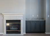 Thumbnail 35 of 50 - a fireplace with a mantel and a pair of cabinets next to it