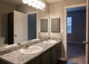 Thumbnail 28 of 50 - a bathroom with a sink and a mirror