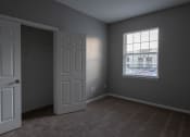 Thumbnail 26 of 50 - an empty bedroom with a white door and a window