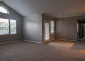 Thumbnail 19 of 50 - an empty living room with a window and a door