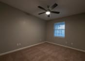 Thumbnail 23 of 50 - an empty room with a ceiling fan and a window