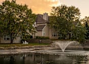 Thumbnail 43 of 44 - A house with a fountain in front of it.