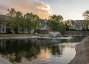 Thumbnail 1 of 50 - a pond with a fountain in front of a building