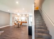 Thumbnail 2 of 18 - A living room with a dining table and chairs.