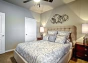 Thumbnail 22 of 37 - model bedroom with ceiling fan and carpet and queen size bed and walk-in closet