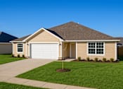 Thumbnail 15 of 15 - A house with a brown roof and a white garage door.