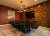 Thumbnail 8 of 44 - a conference room with a table and chairs and a tv  at The Clearing at ONE28, Olathe, KS