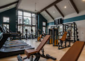 Thumbnail 9 of 44 - a gym with treadmills and other exercise equipment and a large window  at The Clearing at ONE28, Olathe, Kansas