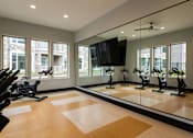 Thumbnail 10 of 44 - the gym has a large mirror and a slew of exercise equipment  at The Clearing at ONE28, Olathe, Kansas