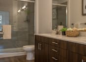 Thumbnail 21 of 44 - an image of a bathroom with a shower and a toilet  at The Clearing at ONE28, Olathe, Kansas