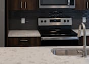 Thumbnail 25 of 44 - a kitchen with a stove and a microwave at The Clearing at ONE28, Olathe, Kansas