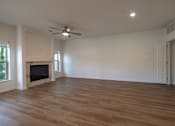 Thumbnail 30 of 44 - a living room with a fireplace and a ceiling fan at The Clearing at ONE28, Kansas